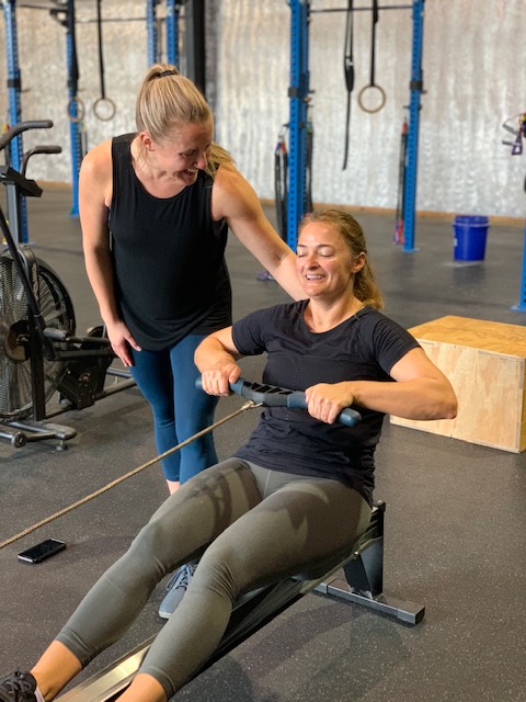 A personal trainer with her female client